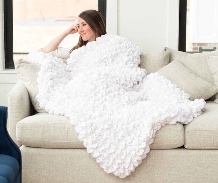 Woman wrapped in a self-weighted textile blanket